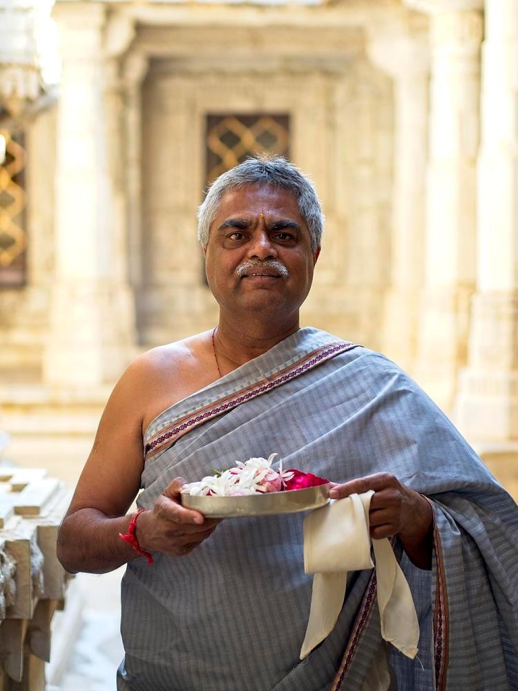 A priest makes an offering at the Jain Temple, Udaipur, Rajasthan, India by Sam Davis Professional Travel Portrait Photographer